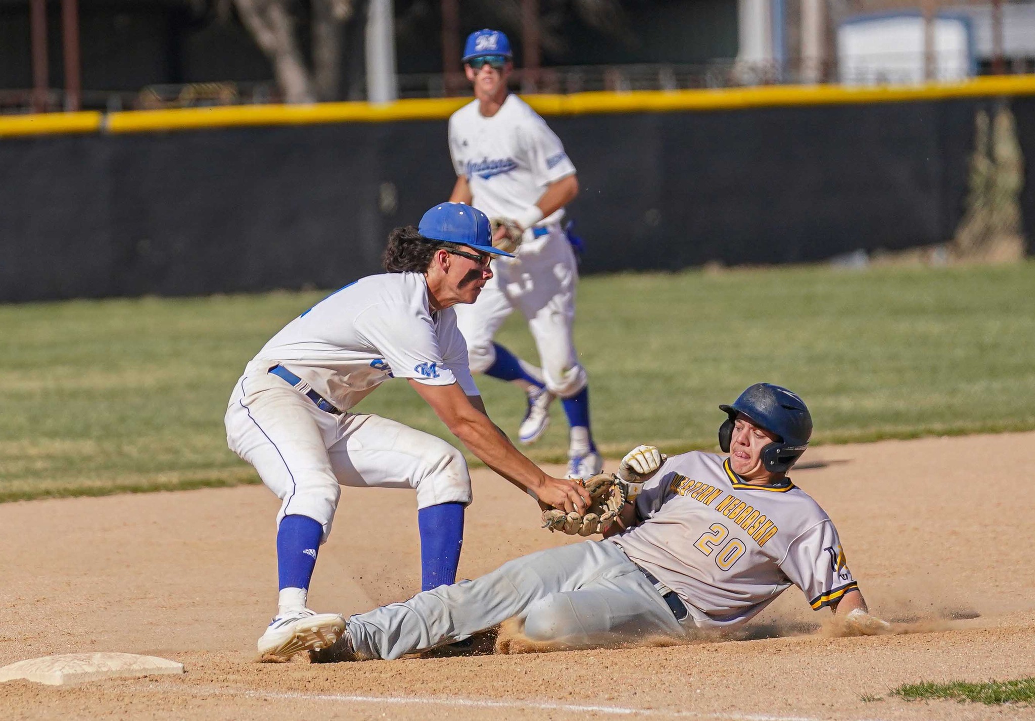 Will Harbison slides into third base during their game on Thursday in McCook. (photo courtesy of the McCook CC Facebook page).