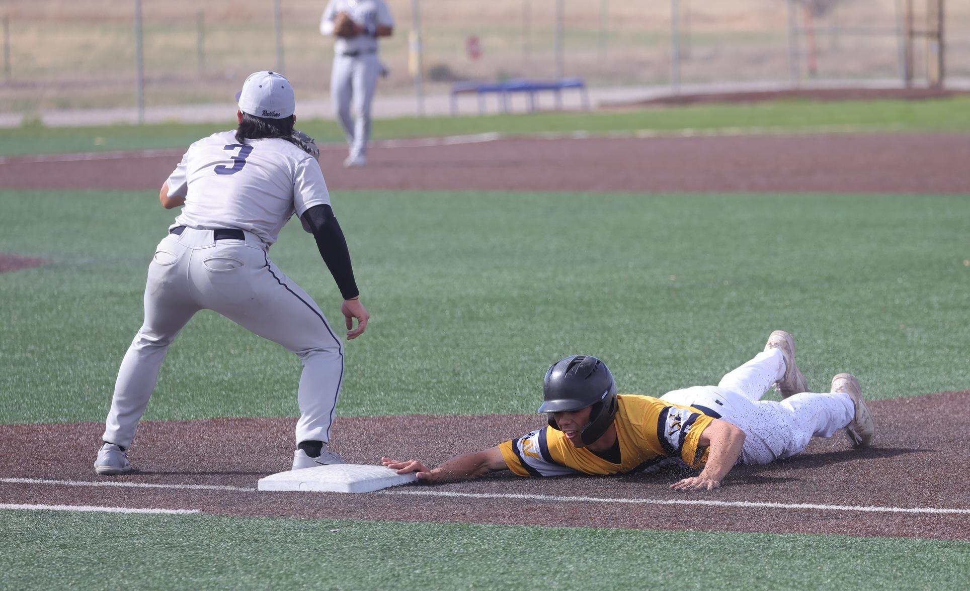Cooper Wilson slides headfirst back into first base on a pick-off attempt in game two.