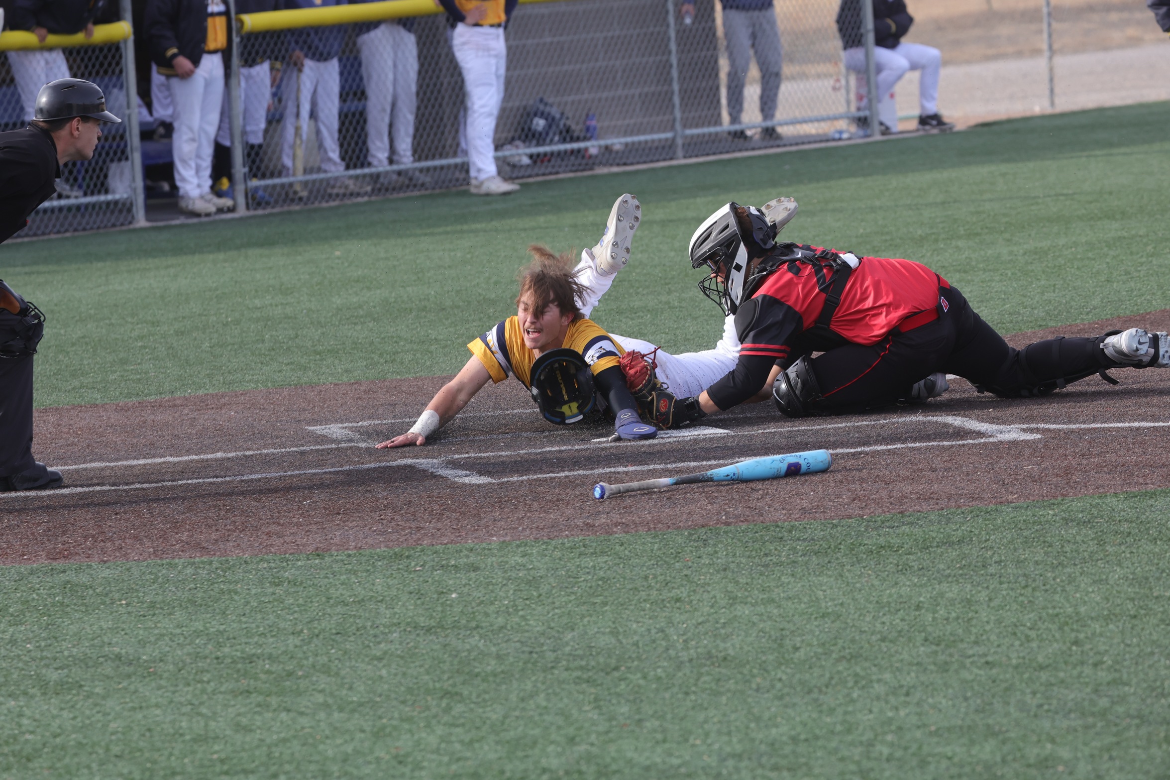 Payton Denny just gets into home plate to score a run before the tag by the Dawson catcher.