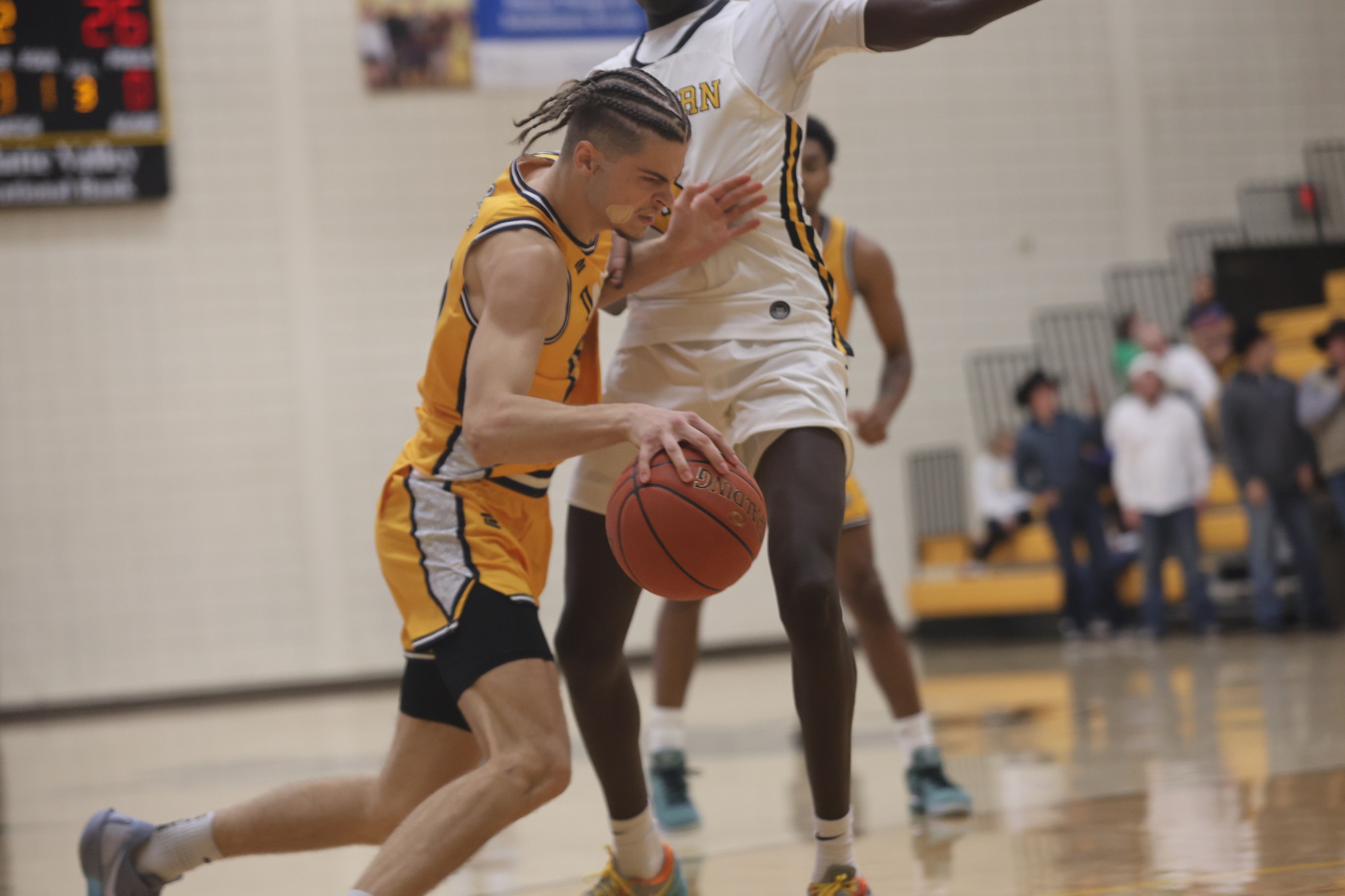 WNCC's Toms Linis uses his arm to make room as he dribbles to the paint.