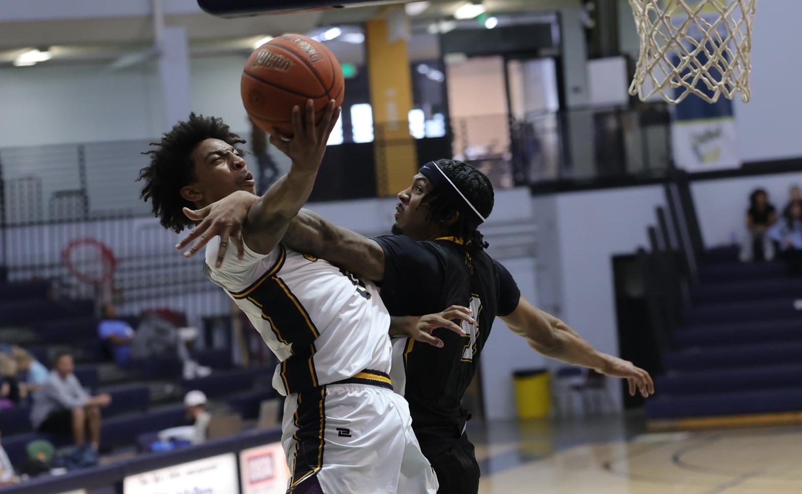 Xavier Kirkpatrick gets fouled going up for a basketball against North Platte on Sunday.