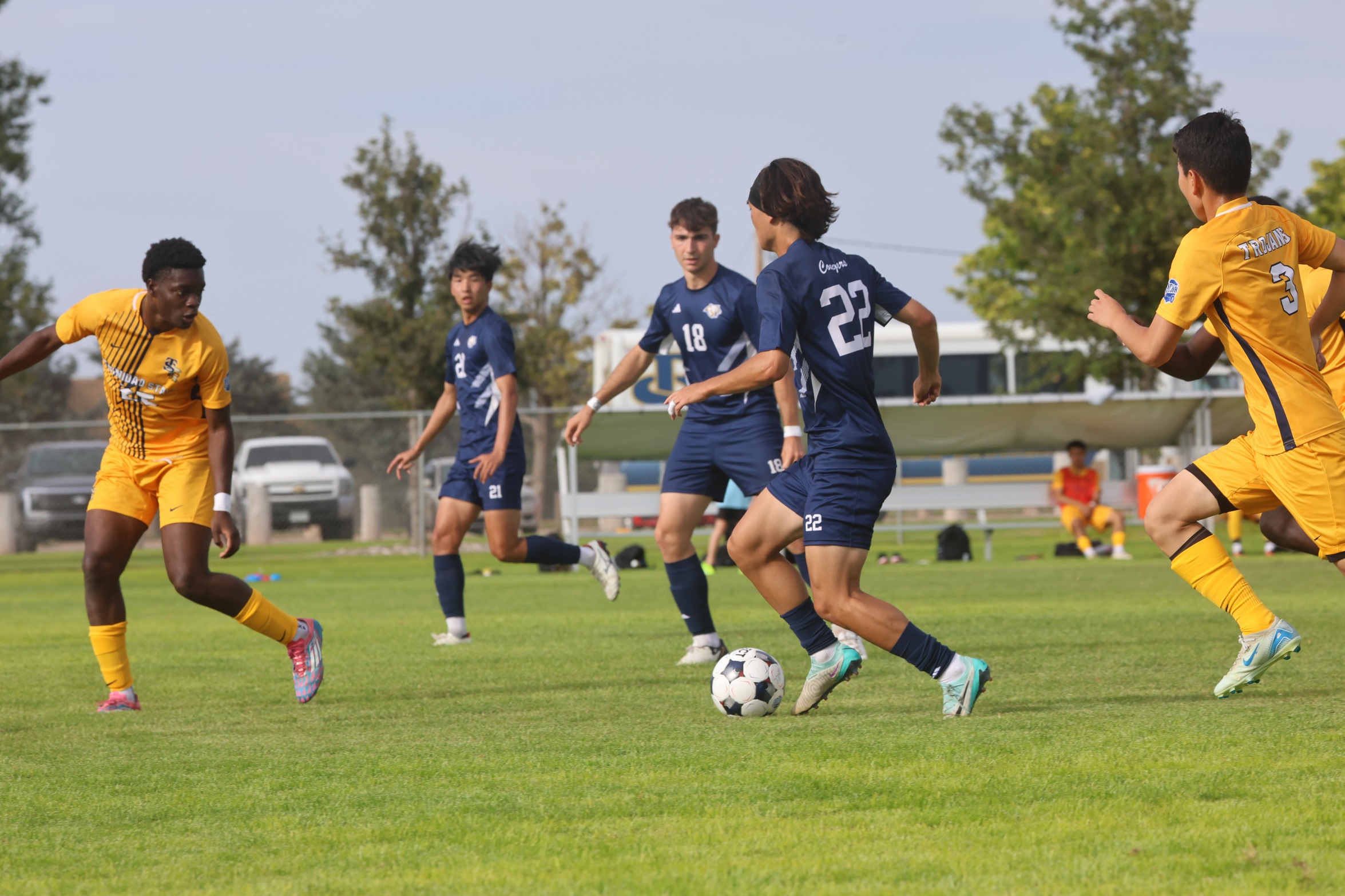 Sean Kim races up the field as he prepares to pass the ball during their game with Trinidad on Saturday.