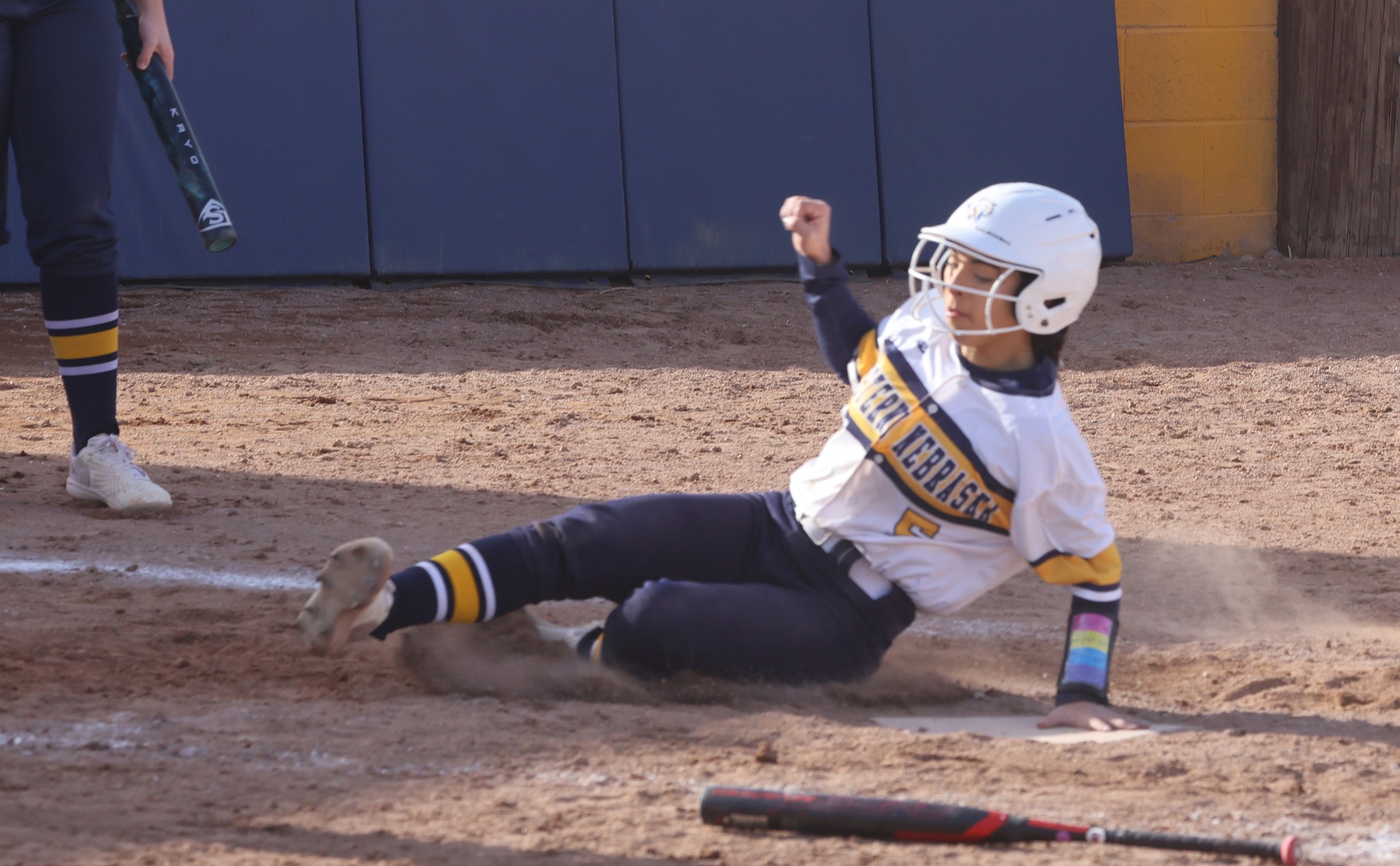 ViVi-Anne Amparan slides into home plate with the game-ending run in the first game for the Cougars 17-9 win.