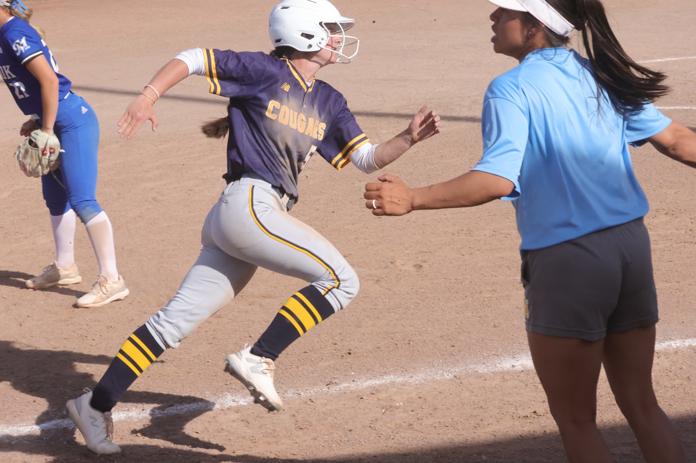 Ellie Soper rounds third as she scores in the second game against McCook on an Adi Duke double.