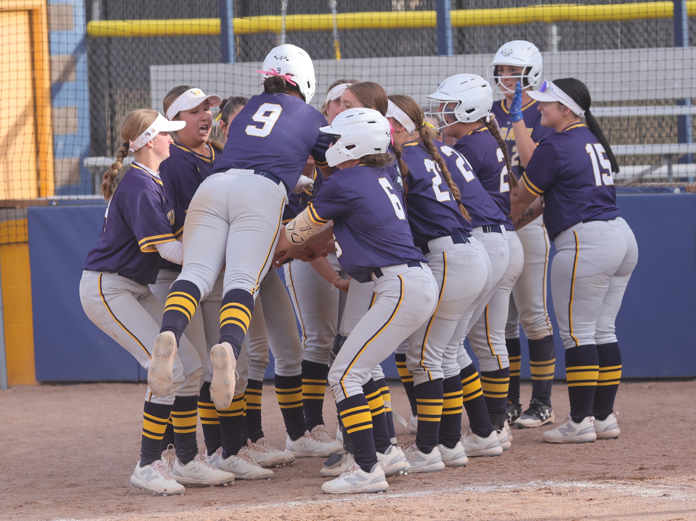 Gracie Holm gets ready to jump on her teammates after hitting a home run against NJC earlier this season.