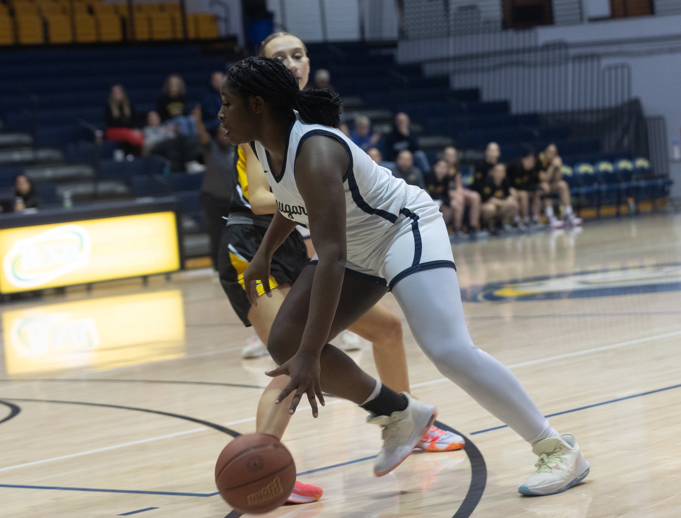 Mackenzie Joseph dribbles to the basket against LCCC.