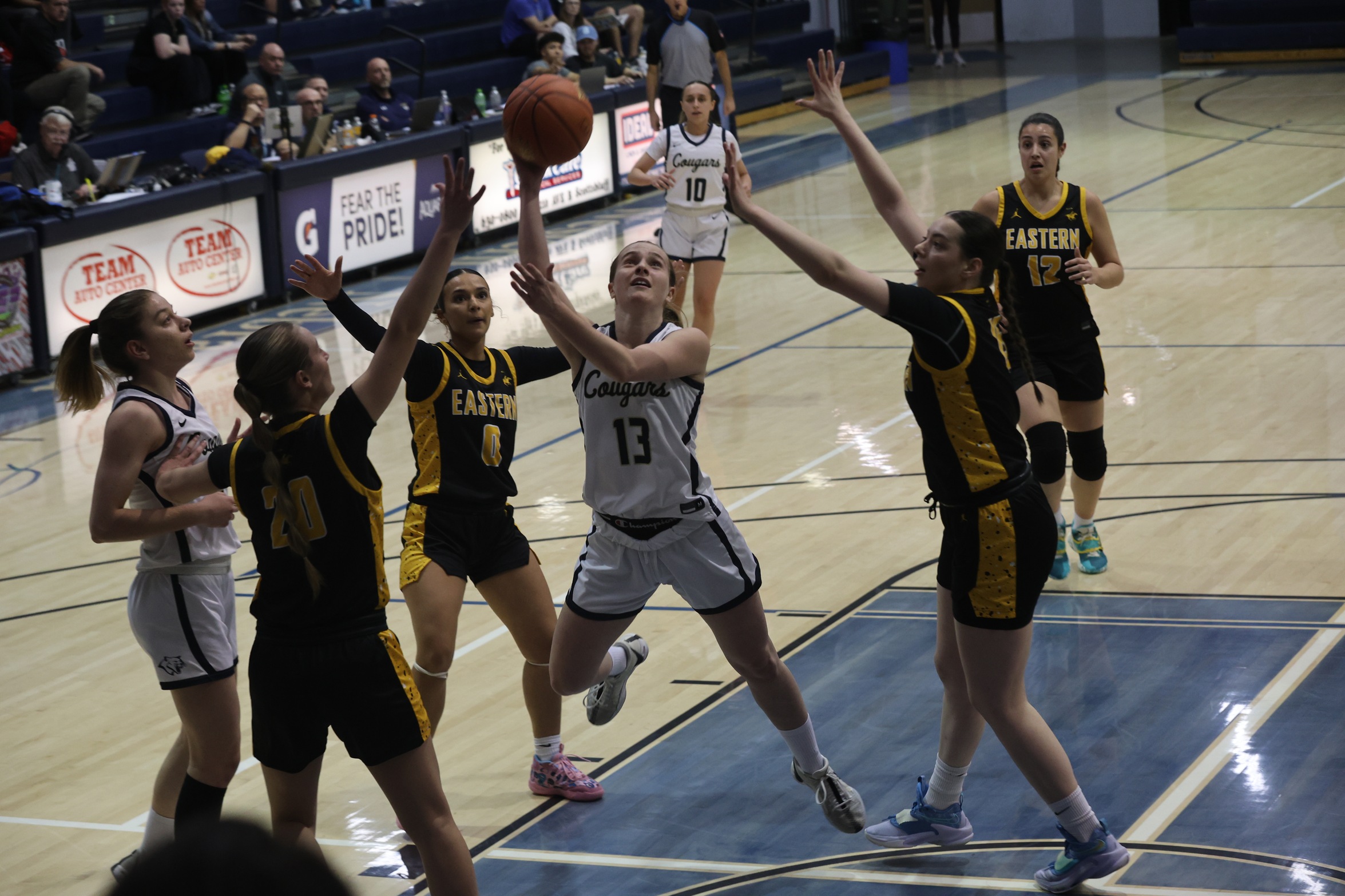 Laura Montiel drives the lane and goes up for two points in the first half against EWC on Thursday in the quarterfinals of the regional tourney at Cougar Palace.