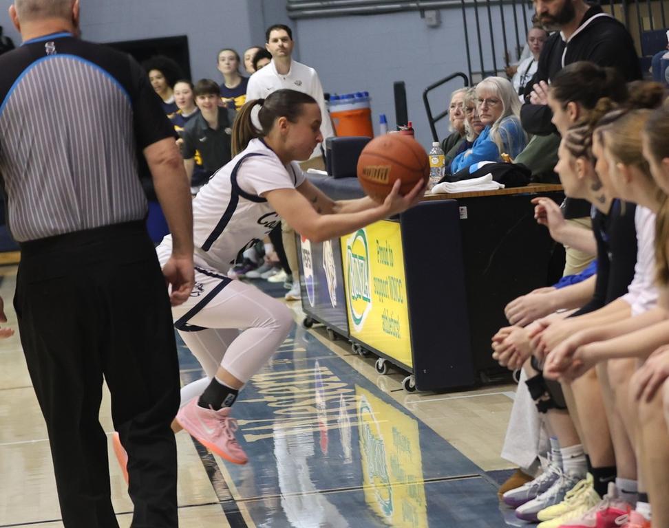 Helena Kuck makes a save on the sidelines in front of the McCook bench in the first half.