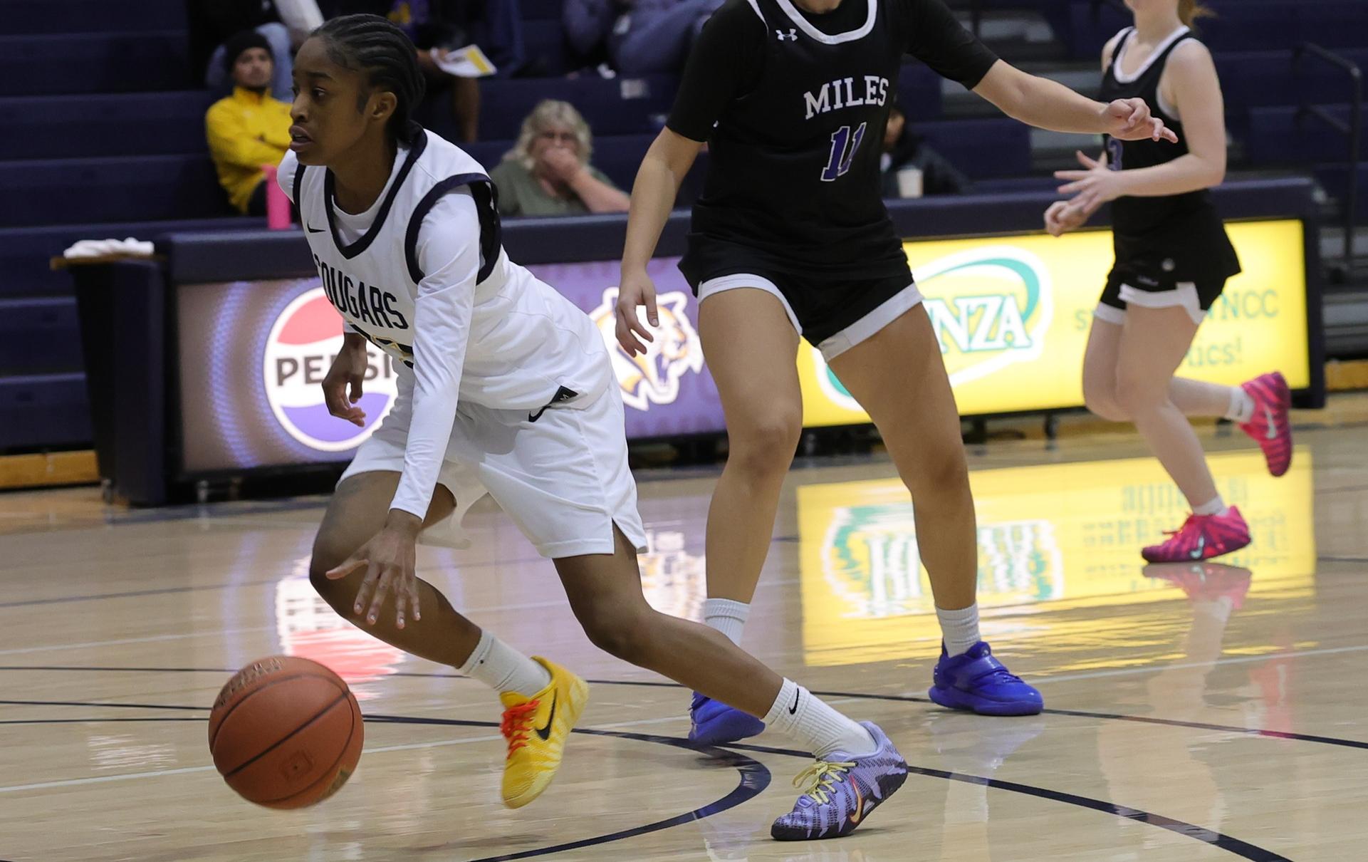 Charisma Johnson drives to the bucket against Miles in November.