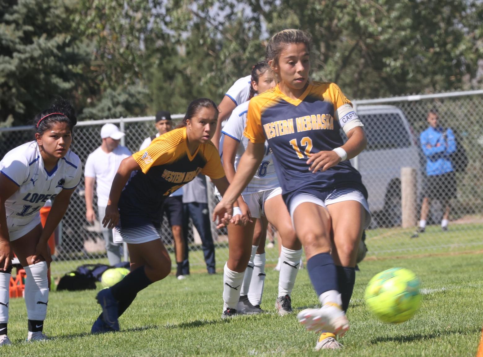 Kicking the ball to the net for a shot.