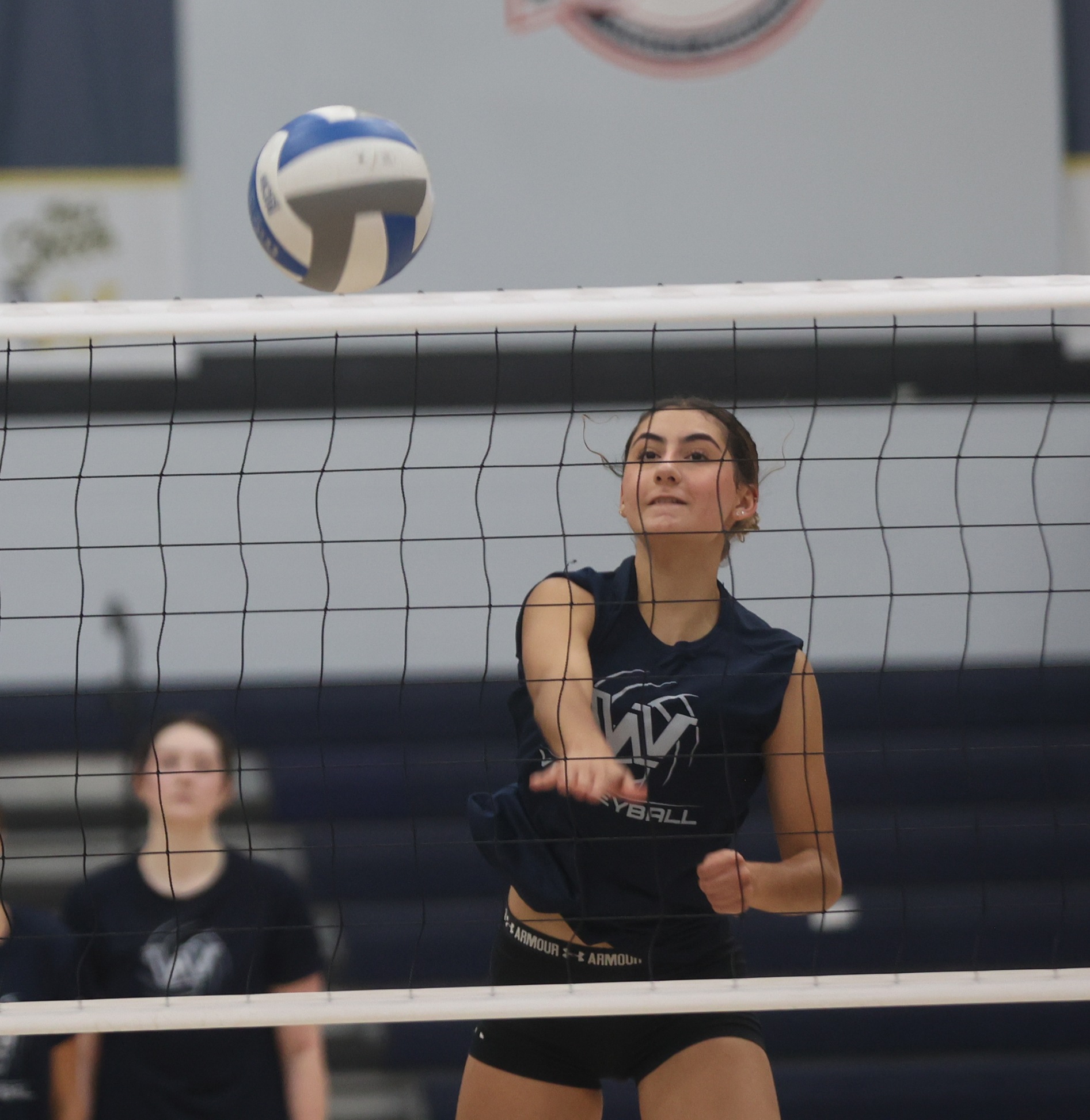 Volleyball player hitting in Monday practice.
