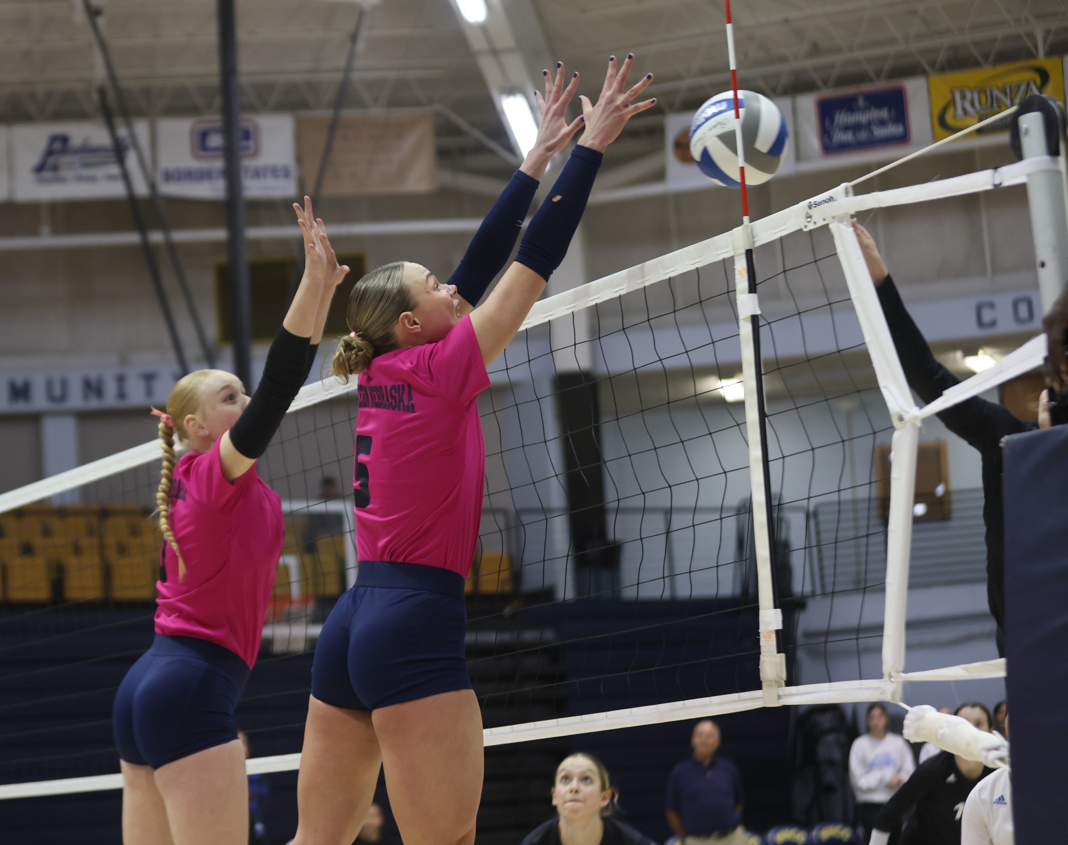 Finja Schul and Lilly Zwart go up for a block on a McCook hitter.