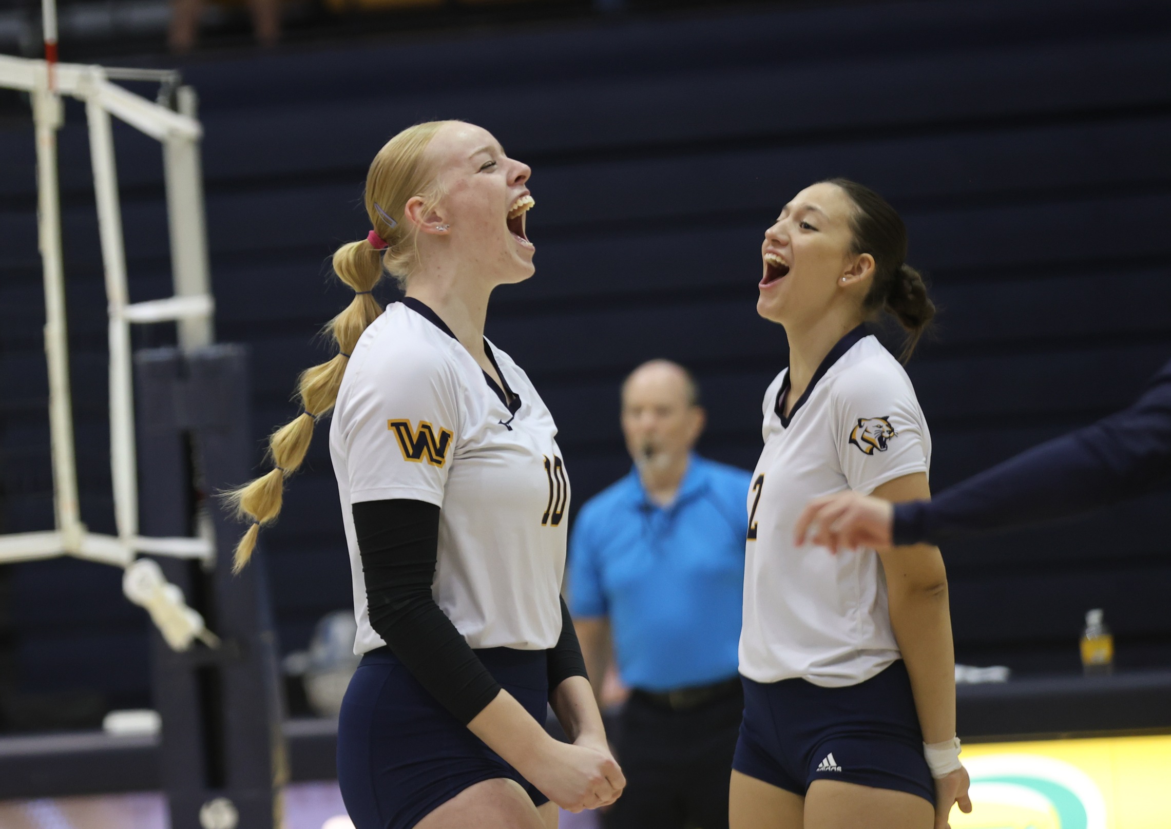 Cougar players celebrate a point in a match earlier this year at home.