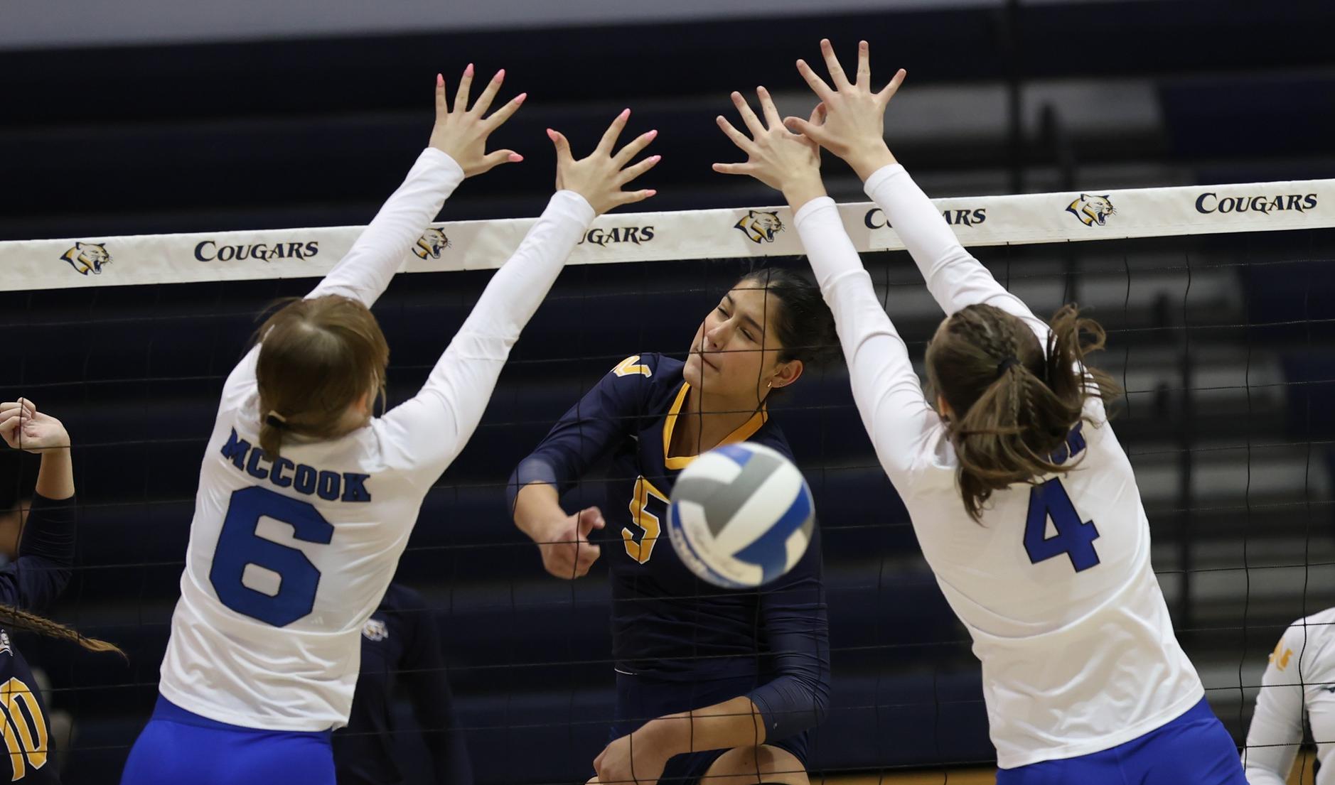 WNCC's Eli Braithwaite hits the ball between the double block of McCook's Paulina Fisher and Bobbi Starkebaum. WNCC won in straight sets.